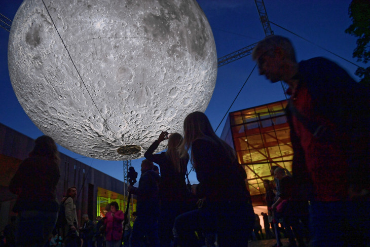 MTI/PAP/Marcin Obara-Luke Jerram brit művész a Hold múzeuma című installációját fényképezi egy látogató a varsói Kopernikusz Tudományos Központnál 2019. május 30